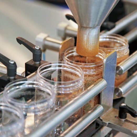 industrial dispenser in glass jars, food industry, conveyor line