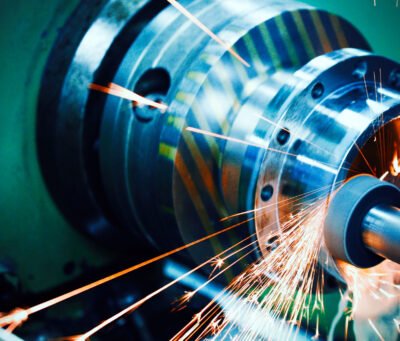 sparks flying while machine griding and finishing metal in factory