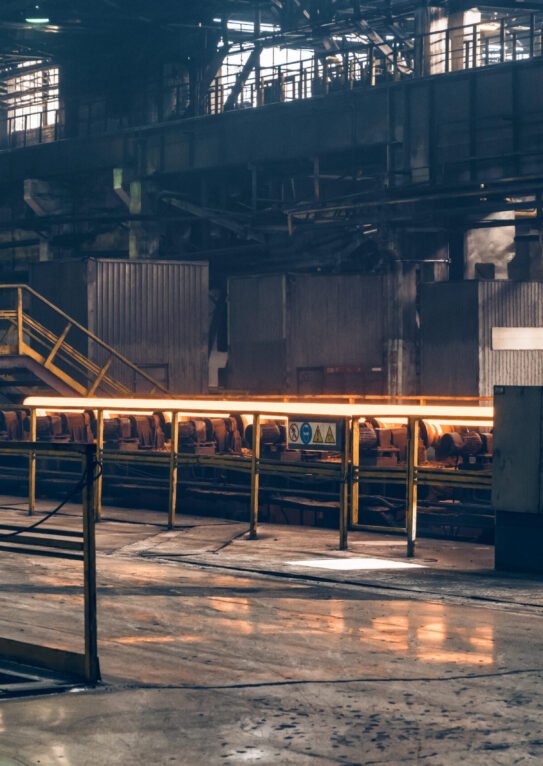 Hot steel pipe on the conveyor in Iron and Steel Factory or Pipe Mill located in Taganrog South of Russia